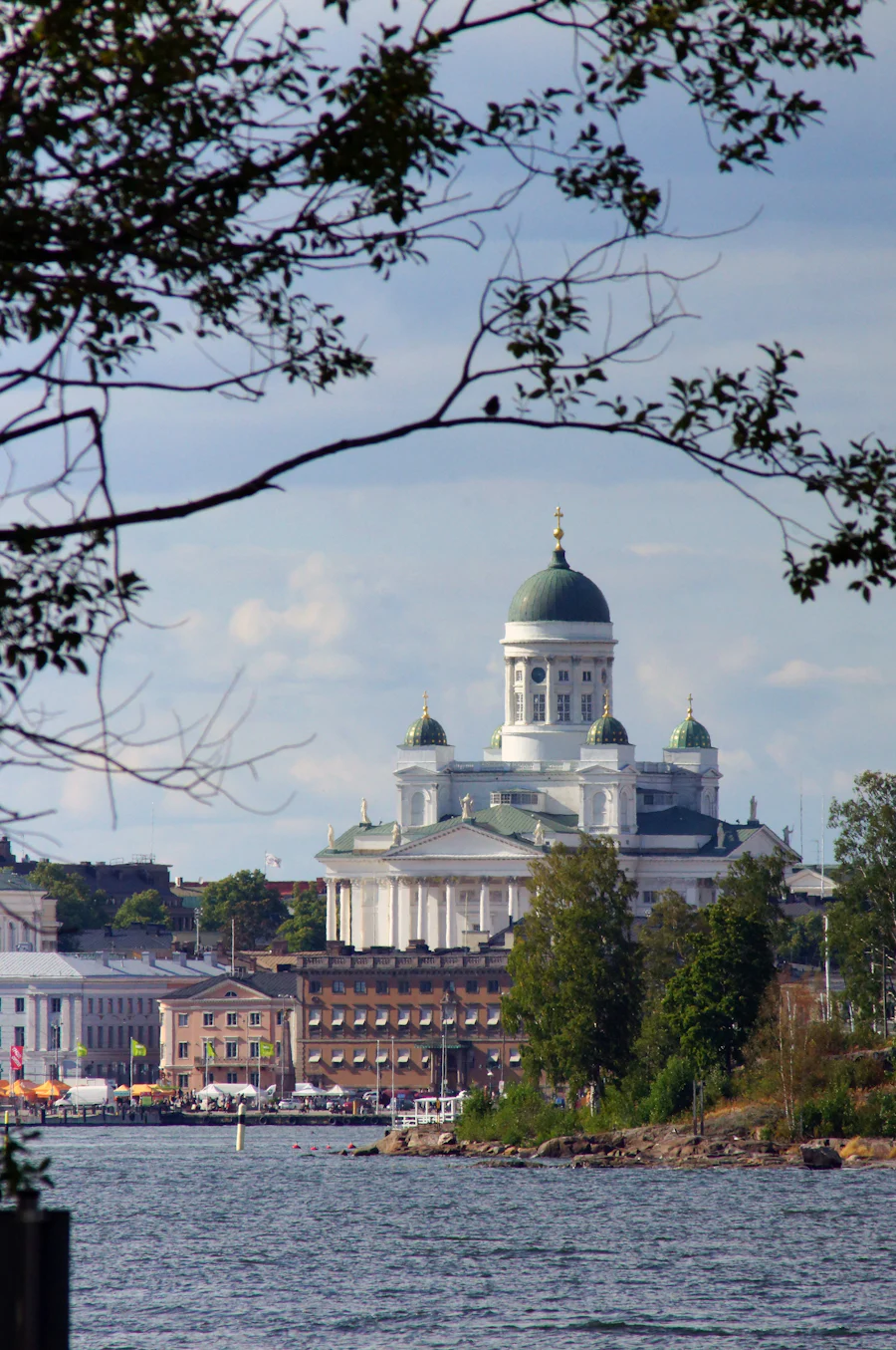 Helsinki Cathedral seen across the water, framed by trees